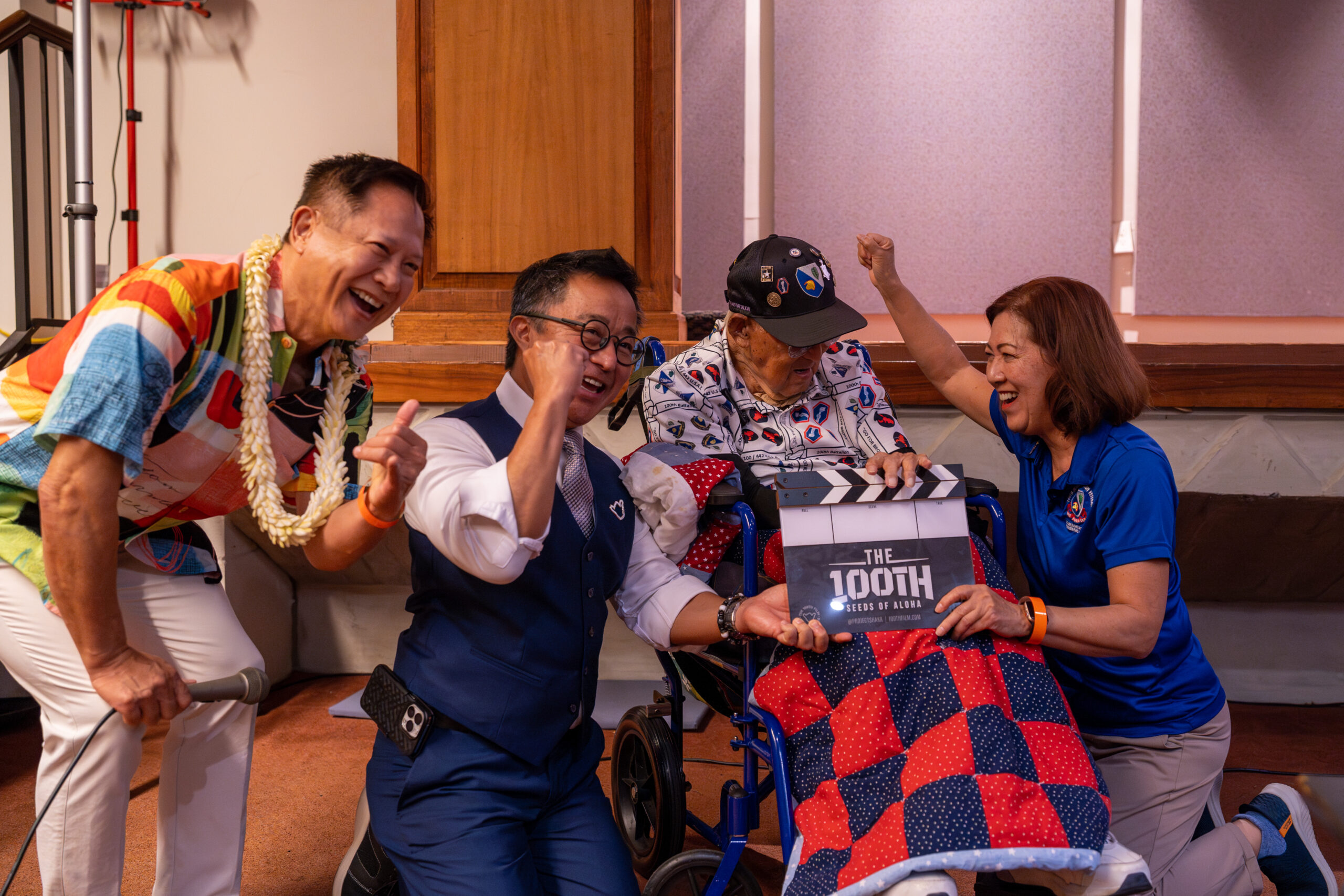 Steve Sue, Sen Glen Wakai, Dr. Taka Manago and Kathi Hayashi clapper in "The 100th, Seeds of Aloha" film kickoff at the Hawaiʻi State Capitol.